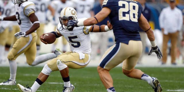 Georgia Tech quarterback Justin Thomas (5) tries to evade Pittsburgh linebacker Anthony Gonzalez (28) in the first quarter of an NCAA football game, Saturday, Oct. 25, 2014, in Pittsburgh. (AP Photo/Keith Srakocic)