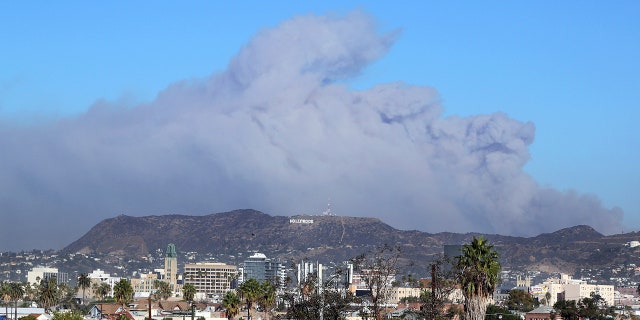 Smoke from the Creek wildfire in the San Gabriel Mountains, a range behind the Hollywood Hills, looms over Los Angeles.