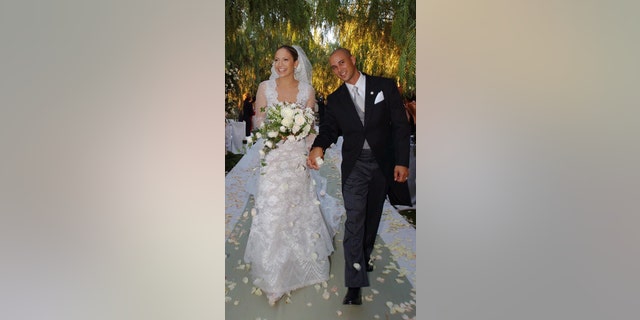 Actress and singer Jennifer Lopez, 31, holds hands with choreographer Cris Judd, 32, during their wedding ceremony, in Calabasas, Calif.