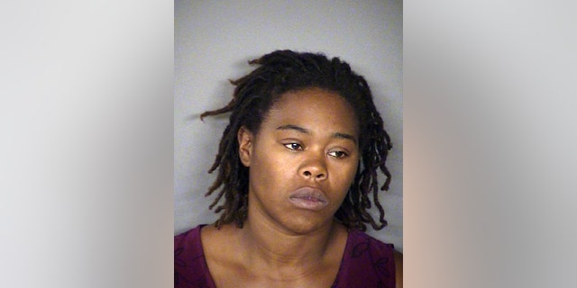 This undated handout photo provided by the Texas Department of Criminal Justice shows Cheryl Reed, the mother of the two young children found chained and leashed outside a San Antonio home, who is charged with two counts of injury to a child. Bexar County sheriff's spokesman James Keith said Friday, May 6, 2016, that the two children, along with six others found inside the home, are in state custody. The six other children showed no signs of physical abuse. (Bexar County Sheriff's Office via AP)