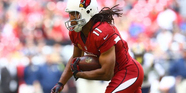 Dec 8, 2013; Phoenix, AZ, USA; Arizona Cardinals wide receiver Larry Fitzgerald (11) runs the ball in the first quarter against the St. Louis Rams at University of Phoenix Stadium. Mandatory Credit: Mark J. Rebilas-USA TODAY Sports