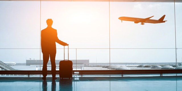 business man with luggage waiting in the airport