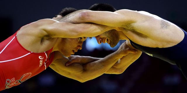 BEIJING - AUGUST 19: Henry Cejudo (red) of the United States competes against Besarion Gochashvili of Georgia during the 55kg freestyle wrestling event at the China Agriculture University Gymnasium on Day 11 of the Beijing 2008 Olympic Games on August 19, 2008 in Beijing, China. (Photo by Jed Jacobsohn/Getty Images)