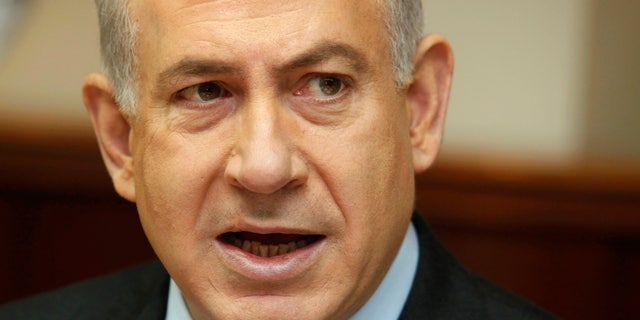 FILE - In this Dec. 16, 2012 file photo, Israeli Prime Minister Benjamin Netanyahu attends the weekly cabinet meeting in his Jerusalem office. Netanyahu’s decision to bring a dovish rival into his Cabinet appears to be backfiring, drawing heavy criticism both in Israel and from the Palestinians and suddenly complicating the task of forming a viable coalition government. It is now uncertain whether Netanyahu will meet an initial deadline next week for forming a new coalition, and rivals are openly talking about the possibility of forcing new elections, just a month after a parliamentary election ended in virtual deadlock. (AP Photo/Gali Tibbon, Pool, File)
