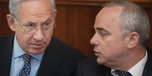 FILE - In this Monday, July 30, 2012 file photo, Israeli Prime Minister Benjamin Netanyahu, left, sits together with Finance Minister Yuval Steinitz, as they attend the weekly cabinet meeting in his Jerusalem office. Steinitz on Monday said taking military action against Iran’s nuclear program is still an option, despite last week’s framework deal between world powers and the Islamic Republic. (AP Photo/Sebastian Scheiner, File)