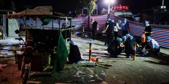 In this photo released by China's Xinhua News Agency, investigators work early Friday, June 16, 2017, at the scene of an explosion outside a kindergarten in Fengxian County in eastern China's Jiangsu Province.