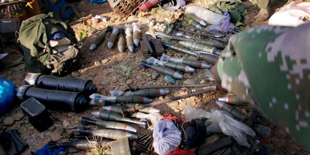 In this photo taken December 15, 2012, and released Monday, Jan. 7, 2013, by Free Burma Rangers, Kachin rebels display the ammunitions they seized from Myanmar soldiers in Laiza, northern Myanmar. Ethnic Kachin rebels in Myanmar accused government troops of launching two artillery attacks Sunday against the city that serves as their headquarters, but no casualties or significant damage were reported. (AP Photo/Free Burma Rangers)