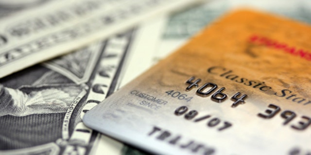 Close up picture of credit card puted on dollars