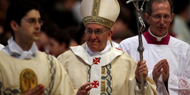 Pope Francis leaves at the end of a mass where he ordained ten new priests in St. Peter's Basilica at the Vatican, Sunday, April 21, 2013. (AP Photo/Gregorio Borgia)