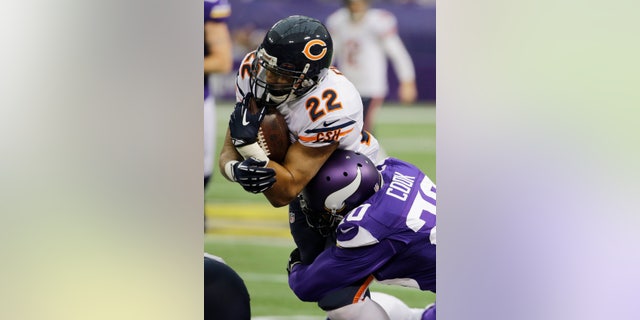 Chicago Bears running back Matt Forte (22) is tackled by Minnesota Vikings cornerback Chris Cook during the first half of an NFL football game on Sunday, Dec. 1, 2013, in Minneapolis. (AP Photo/Ann Heisenfelt)