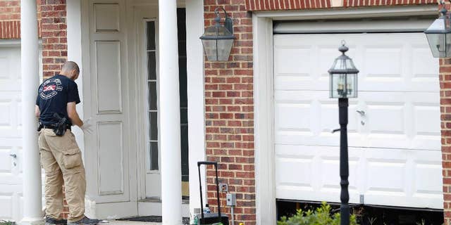 A law enforcement officer at Nicholas Young's home in August.