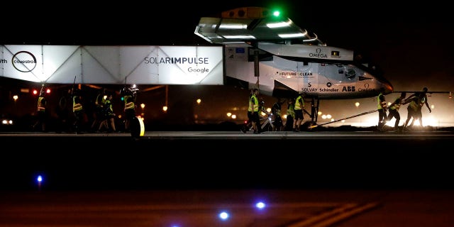 May 2, 2016: Grounds crew pull pilot Andre Borschberg and the Swiss-made Solar Impulse 2 plane to the hanger after landing in Goodyear, Ariz.