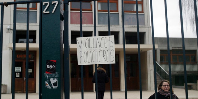 A placard reading "police violence" is displayed on the entrance of the Henri Bergson college after a protest against alleged police abuses, in Paris, Thursday, Feb. 23, 2017. (AP Photo/Thibault Camus)