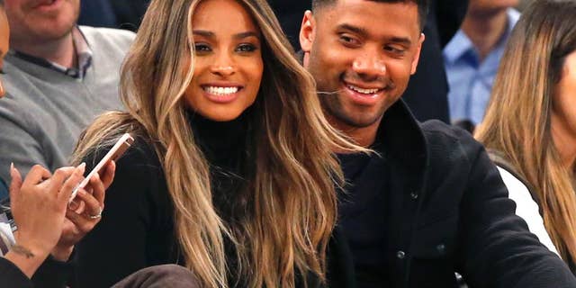 In this Feb. 9, 2016 file photo, singer Ciara, second from left, and Seattle Seahawks quarterback Russell Wilson sit courtside while attending an NBA basketball game between the New York Knicks and the Washington Wizards in New York.