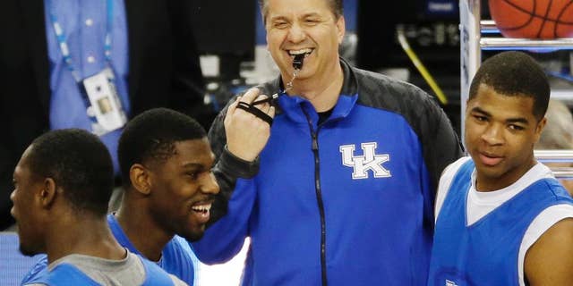 Kentucky head coach John Calipari shares a light moment with the team during practice for their NCAA Final Four tournament college basketball semifinal game Friday, April 4, 2014, in Dallas. Kentucky plays Wisconsin on Saturday, April 5, 2014. (AP Photo/Tony Gutierrez)
