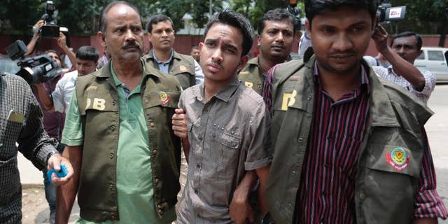Members of Bangladesh Police Detective Branch escort Mohammed Sumon Hossain in Dhaka, Bangladesh, Thursday, June 16, 2016. Police counter-terrorism chief Monirul Islam told reporters that Hossain is charged with taking part in the October attack on publisher Ahmed Rashid Tutul who worked on books by a prominent atheist writer who was killed in a separate attack. (AP Photo)