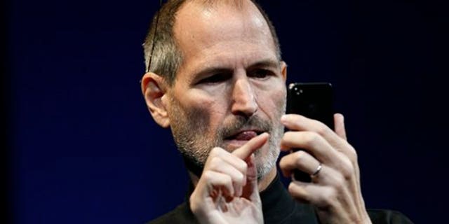 Apple CEO Steve Jobs uses the new iPhone during the Apple Worldwide Developers Conference, Monday, June 7, 2010, in San Francisco.