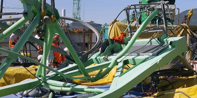 A part of a collapsed crane is seen fallen on the ground at Samsung Heavy Industries' shipyard on Geoje Island, South Korea, Monday, May 1, 2017. Samsung Heavy Industries say a crane has collapsed at its shipyard in South Korea, killing several workers and injuring many more. (Lee Jung-hoon/Yonhap via AP)