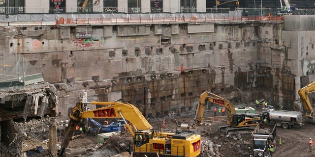 FILE - Construction workers and equipment excavate the southeastern corner of the World Trade Center site on in this Jan. 8, 2008 file photo taken in New York.