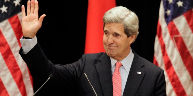 U.S. Secretary of State John Kerry waves after his lecture to students at Tokyo Institute of Technology in Tokyo Monday, April 15, 2013. Kerry is here as part of Asian tour amid a tense situation over a possible missile launch by North Korea. (AP Photo/Junji Kurokawa, Pool)