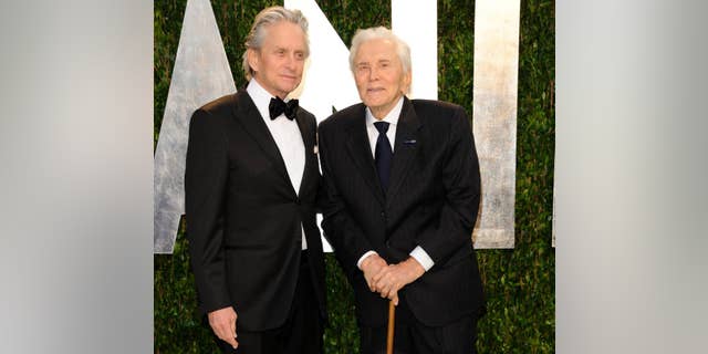 Michael Douglas, left, and Kirk Douglas arrive at the Vanity Fair Oscar party in West Hollywood, Calif., in February 2012.