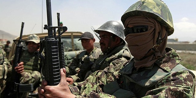 April 27: Afghan National Army (ANA) soldiers arrive at the gate of the Afghan air force compound in Kabul.