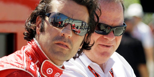 FILE - In this Oct. 1, 2010, file photo, IndyCar driver Dario Franchitti, left and team owner Chip Ganassi talk before practice for the IRL Indy 300 auto race at Homestead-Miami Speedway in Homestead, Fla. When Franchitti made a rare call from Scotland to his boss, Chip Ganassi knew immediately something was wrong. He could hear the heartbreak over the line. Franchitti then delivered the news: Doctors had told him it was time to quit. (AP Photo/Terry Renna, File)
