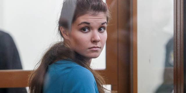 Varvara Karaulova, who was detained last year in Turkey as she was reportedly trying to cross the border into Syria, sits in a cage in the Moscow District Military Court in Moscow, Russia, Thursday, Dec. 22, 2016. A Moscow court has sentenced a 20-year old university student to four and a half years in prison for trying to join Islamic State group fighters in Syria. (Andrey Nikerichev/Moscow news agency via AP)