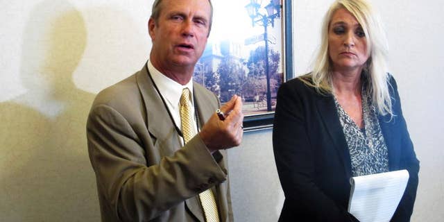 Logan County Prosecutor William Goslee, left, talks about a woman accused of killing her three sons over a 13-month span, alongside Melanie Engle, executive director of Logan County Children's Services, whose agency fought to keep a son who died from being returned home, on Wednesday, Aug. 19, 2015, in Bellefontaine, Ohio. Goslee said the system couldn't have foreseen such erratic behavior by the suspect. (AP Photo/Andrew Welsh-Huggins)