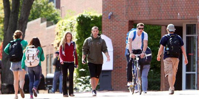 Students are pictured walking through a college campus.