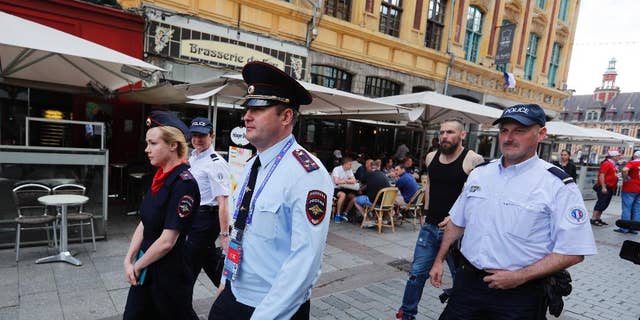 Russian police officers walk through a square in downtown Lille, Wednesday, June 15, 2016 after being called into to bolster security ahead of the Euro 2016 Group B soccer match between Russia and Slovakia at the Pierre Mauroy stadium in Villeneuve d’Ascq, near Lille. UEFA gave Russia a suspended disqualification from the tournament after violence at their previous match against England in Marseille. (AP Photo/Darko Bandic)