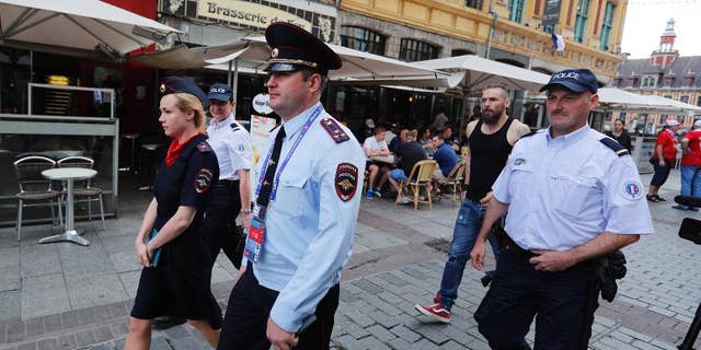 Russian police officers walk through a square in downtown Lille, Wednesday, June 15, 2016 after being called into to bolster security ahead of the Euro 2016 Group B soccer match between Russia and Slovakia at the Pierre Mauroy stadium in Villeneuve d’Ascq, near Lille. UEFA gave Russia a suspended disqualification from the tournament after violence at their previous match against England in Marseille. (AP Photo/Darko Bandic)