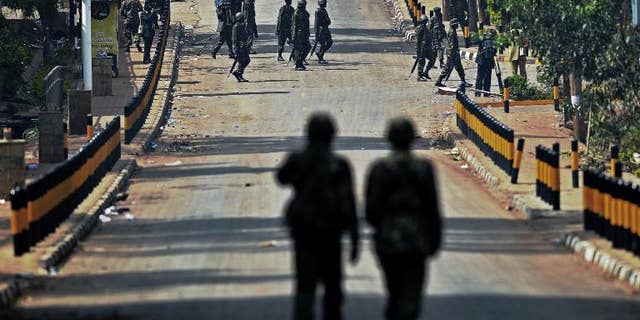Kenyan soldiers walk on September 26, 2013 on the road outside the Westgate Mall in Nairobi