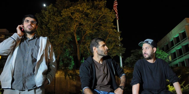 Three freed Guantanamo detainees during protest outside the U.S. embassy in Montevideo, in April 2015.