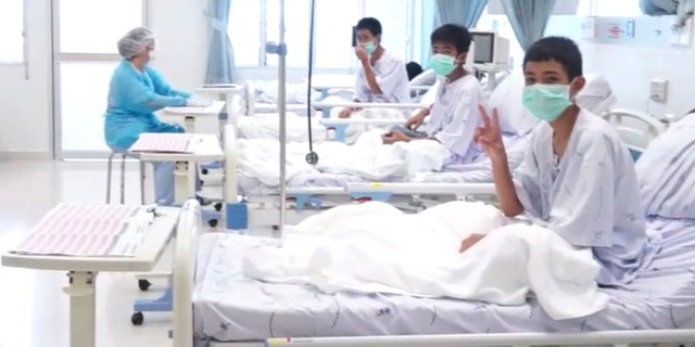 In this image made from video, released by the Thailand Government Spokesman Bureau, three of the 12 boys are seen recovering in their hospital beds after being rescued along with their coach from a flooded cave in Mae Sai, Chiang Rai province, northern Thailand. (Thailand Government Spokesman Bureau via AP)