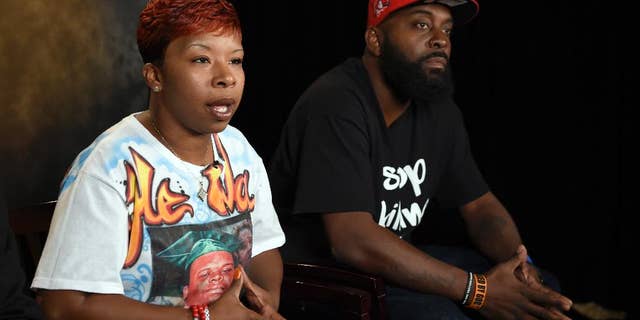FILE - In this Sept. 27, 2014 file photo, the parents of Michael Brown, Lesley McSpadden, left, and Michael Brown, Sr., right, sit for an interview with The Associated Press in Washington. Attorneys representing Ferguson, Mo., its former police chief and an ex-officer in a wrongful-death lawsuit by Brown's parents are pressing the latest quest for access to any of the late 18-year-old's juvenile records. Anthony Gray, a Brown family attorney, has said any brush by Brown with the juvenile court system is irrelevant to whether Brown's 2014 death resulted from excessive police force.(AP Photo/Susan Walsh, File)