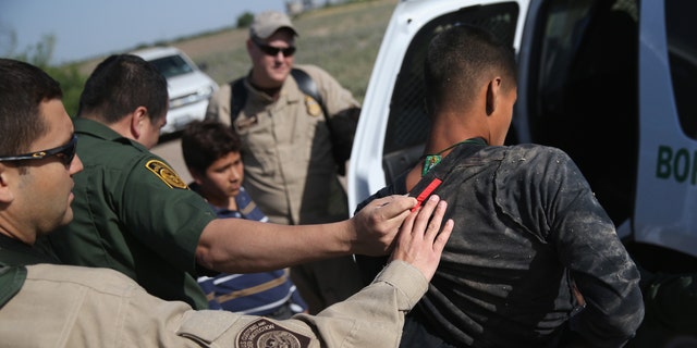 MISSION, TX - APRIL 11:  U.S. Border Patrol and U.S. Air and Marine agents work together to detain an undocumented immigrant after chasing him down near the U.S.-Mexico border on April 11, 2013 near Mission, Texas. A group of 16 immigrants from Mexico and El Salvador said they crossed the Rio Grande River from Mexico into Texas during the morning hours before they were caught. The Rio Grande Valley sector of has seen more than a 50 percent increase in illegal immigrant crossings from last year, according to the Border Patrol. Agents say they have also seen an additional surge in immigrant traffic since immigration reform negotiations began this year in Washington D.C. Proposed refoms could provide a path to citizenship for many of the estimated 11 million undocumented workers living in the United States. Photo by John Moore/Getty Images)  (Photo by John Moore/Getty Images)