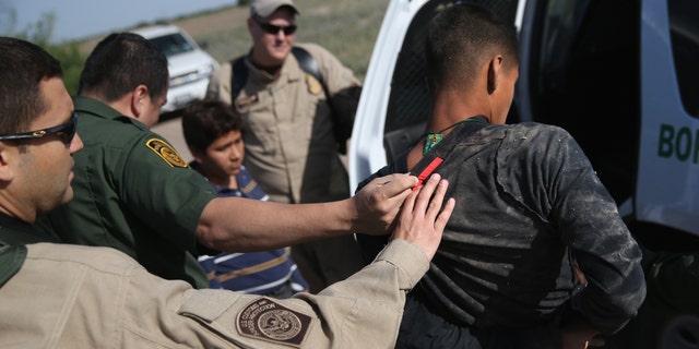 MISSION, TX - APRIL 11: U.S. Border Patrol and U.S. Air and Marine agents work together to detain an undocumented immigrant after chasing him down near the U.S.-Mexico border on April 11, 2013 near Mission, Texas. A group of 16 immigrants from Mexico and El Salvador said they crossed the Rio Grande River from Mexico into Texas during the morning hours before they were caught. The Rio Grande Valley sector of has seen more than a 50 percent increase in illegal immigrant crossings from last year, according to the Border Patrol. Agents say they have also seen an additional surge in immigrant traffic since immigration reform negotiations began this year in Washington D.C. Proposed refoms could provide a path to citizenship for many of the estimated 11 million undocumented workers living in the United States. Photo by John Moore/Getty Images) (Photo by John Moore/Getty Images)