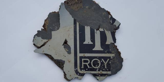 FILE - In this Monday, March 21, 2016, a part of a plane is photographed in Mossel Bay, near Cape Town, South Africa. The part which may be part of a plane engine has been found on the southern coast of South Africa and will be checked to see if it belongs to Malaysia Airlines Flight 370, which vanished two years ago, Malaysian Tranport Minister Liow Tiong Lai said Tuesday, March 22, 2016. (AP Photo/Neels Kruger, File)