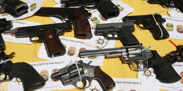 LAKEWOOD, CA - MAY 21: Some of about 125 weapons confiscated during what the federal authorities say is the largest gang takedown in United States history are displayed at a press conference to announce the arrests of scores of alleged gang members and associates on federal racketeering and drug-trafficking charges on May 21, 2009 in the Los Angeles-area community of Lakewood, California. 147 people were indicted in the case involving racially motivated attacks on African-Americans and law enforcement officers. Operation Knockout is the latest of several investigations that found gangs engaged in race-based violence. Two years ago, a Latino gang was charged with waging a violent campaign to drive blacks out of a Los Angeles-area neighborhood that resulted in 20 homicides. Last year, another Latino gang was accused of targeting blacks and killing 14-year-old Cheryl Green, whose death became a community rallying point. In 2006, Avenues gang members Latinos were convicted of assaults and killings of blacks in the 1990s. (Photo by David McNew/Getty Images)