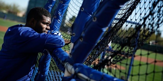Los Angeles Dodgers' Yasiel Puig watches a batter hit during a spring training baseball workout Wednesday, Feb. 25, 2015, in Phoenix. (AP Photo/John Locher)