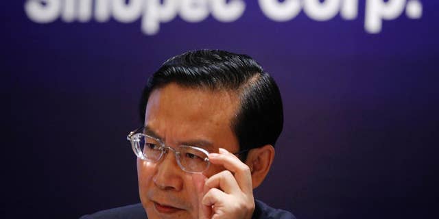 FILE - In this Aug. 24, 2009 file photo, Sinopec then Chairman Su Shulin adjusts his glasses during a press conference in Hong Kong. The governor of China's economically vital eastern province of Fujian has been placed under investigation amid President Xi Jinping's ongoing attack on corruption at all levels of government. Su took over as Fujian governor in 2011 after a lengthy career in the oil industry, which has been a major target of anti-corruption investigators. (AP Photo/Vincent Yu, File)