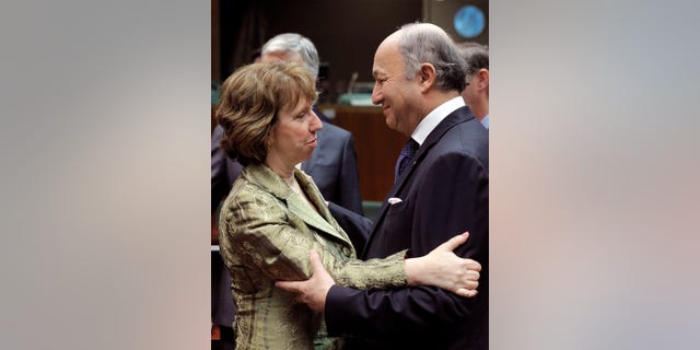 French Foreign Minister Laurent Fabius, right, talks with EU foreign policy chief Catherine Ashton, during the EU foreign ministers meeting, at the European Council building in Brussels, Monday, Dec. 16, 2013. European Union foreign ministers meeting Monday argue that the door remains open for Ukraine to sign an association agreement the EU, even though they criticized the delaying tactics and mixed messages sent by Ukraine President Viktor Yanukovych. (AP Photo/Yves Logghe)