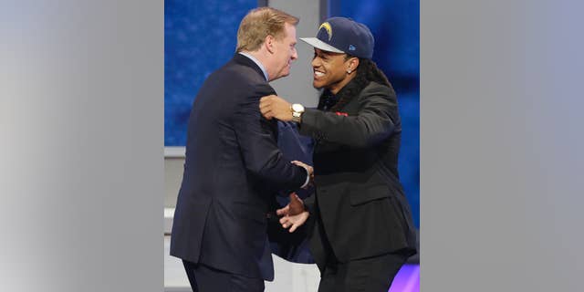 Texas Christian cornerback Jason Verrett is greeted by NFL commissioner Roger Goodell after being selected by the San Diego Chargers as the 25th pick of the first round of the 2014 NFL Draft, Thursday, May 8, 2014, in New York.(AP Photo/Frank Franklin II)