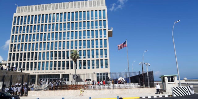 In this photo taken Aug. 14, 2015, a U.S. flag flies at the U.S. embassy in Havana, Cuba. Two more American diplomats who served in Cuba are affected by health attacks in Cuba, raising the total to 21.