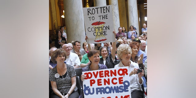 Signs are raised during the Hoosiers Against Common Core rally at the Statehouse, Monday, April 21, 2014. After the rally, participants walked to Government Center South to attend the Indiana Education Roundtable meeting.