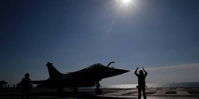 FILE - In this Jan.12, 2016 file photo, a Rafale jet fighter is catapulted on France's flagship Charles de Gaulle aircraft carrier in the Persian Gulf. French warplanes are flying over Iraq Friday Sept. 30, 2016 after France's Charles de Gaulle aircraft carrier rejoined the U.S.-led fight against Islamic State extremists and the coalition prepares to try to take back the city of Mosul. (AP Photo/Christophe Ena, File)