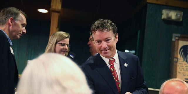 URBANDALE, IA - AUGUST 06:  U.S. Rand Paul (R-KY) (C) greets guest during a breakfast hosted by the Westside Conservative Club at the Machine Shed Restaurant on August 6, 2014 in Urbandale, Iowa.  Paul, who is expected to seek the 2016 Republican presidential nomination, was on a three-day, eight-city tour of Iowa, the first state in the nation to select the presidential nominee.  (Photo by Scott Olson/Getty Images)