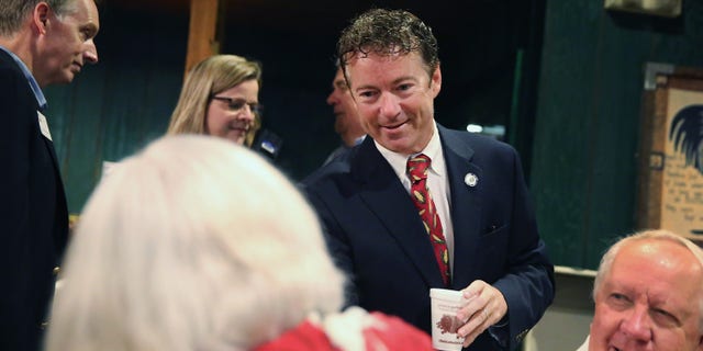 URBANDALE, IA - AUGUST 06: U.S. Rand Paul (R-KY) (C) greets guest during a breakfast hosted by the Westside Conservative Club at the Machine Shed Restaurant on August 6, 2014 in Urbandale, Iowa. Paul, who is expected to seek the 2016 Republican presidential nomination, was on a three-day, eight-city tour of Iowa, the first state in the nation to select the presidential nominee. (Photo by Scott Olson/Getty Images)