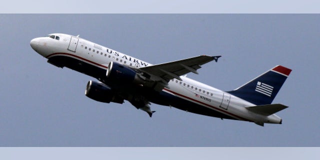 HOLD FOR BUSINESS PHOTO-- This is a US Airways jet taking off from Pittsburgh International Airport on Tuesday, July 23, 2013 in Imperial, Pa. (AP Photo/Gene J. Puskar)